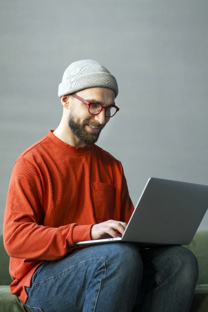 Man completing an online health questionnaire on a laptop
